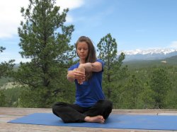 Wrist Flexor Stretch, palm facing body, with a view of Sangre de Cristo Mountains, Colorado