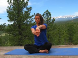 Wrist Extensor Stretch, palm away from body, with view of Sangre de Cristo mountains, Colorado