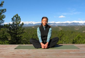 Seated Bound Angle Yoga Pose with a view of the Sangre de Cristo Mountains, Colorad