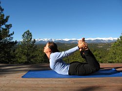 Bow Pose, yoga pose with Sangre de Cristo Mountains of Southern Colorado