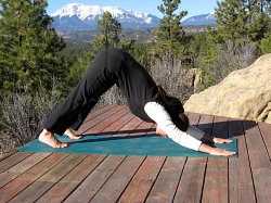 Downward Dog yoga pose with a view of the West Spanish Peak, Colorado