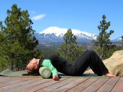 Shoulder stretch on foam roller, arms out to side.