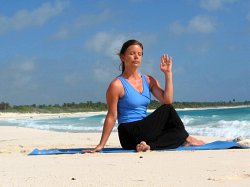 Half Spinal Twist Pose on a beach near Playa del Carmen, Mexico