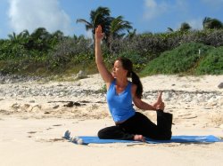Modified Pigeon yoga pose at a beach near Playa del Carmen, Mexico