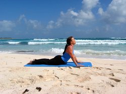 Cobra Pose, yoga pose at a beach near Playa del Carmen, Mexico