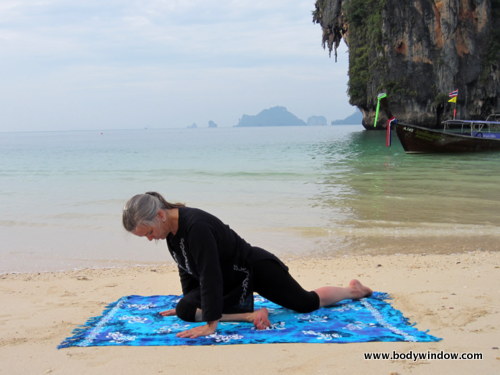 Beginning Pigeon Pose on Pranang Beach, Railay, Thailand Beginning Pigeon Pose on Pranang Beach, Railay, Thailand