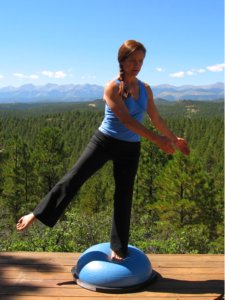 Bosu Ball, standing balance on left leg and another out wide to the side.