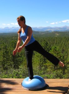 Bosu Ball, standing balance on right leg and another out wide to the side.