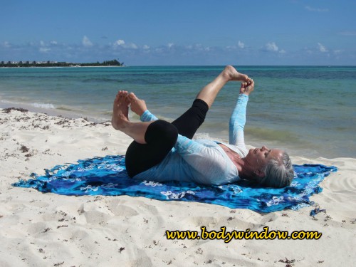 Happy Baby with Right Leg Extension, done on a beach in Playa del Carmen, Mexico.
