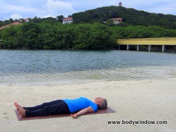 Savasana on a beach in Roatan, Honduras