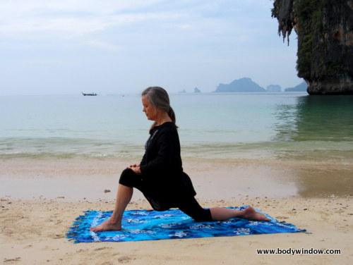 Photo of Elle Bieling doing Dragon Pose in Yin Yoga on Pranang Beach, Railay,

Thailand