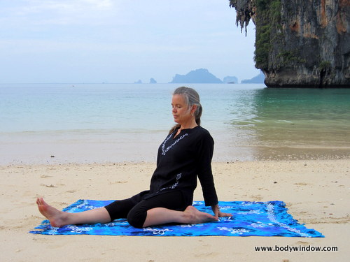 Photo of Elle Bieling doing Saddle Pose in Yin Yoga on Pranang Beach, Railay, Thailand