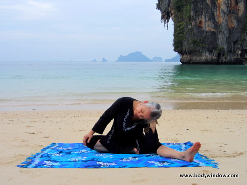 Yin Yoga's, Lateral Half Dragonfly Pose, Leaning to Side with Head in Hand, Pranang Beach, Railay, Thailand