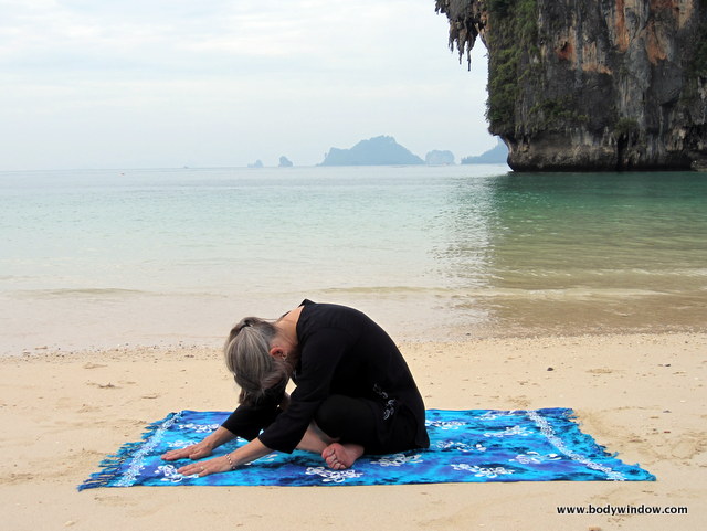 Photo of Elle Bieling doing Square Pose in Yin Yoga on Pranang Beach, Railay, Thailand